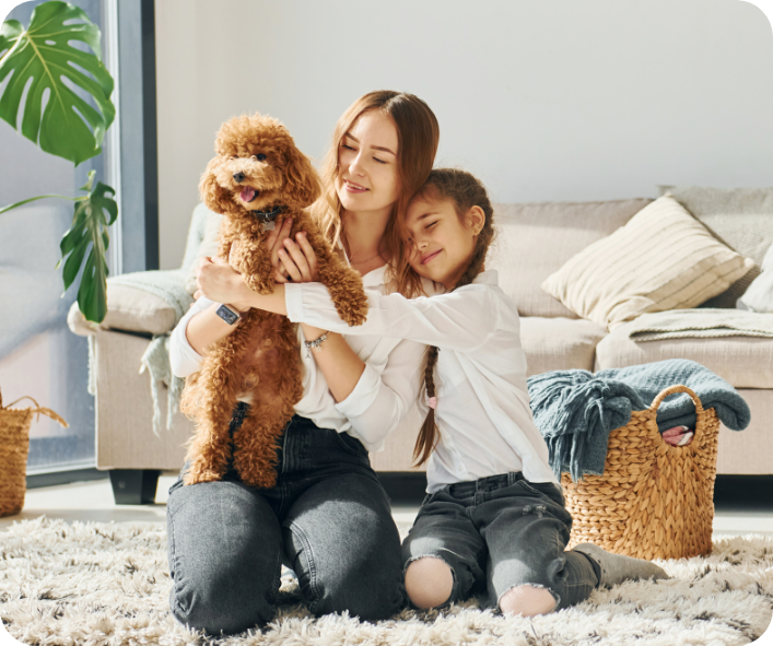 family playing with little poodle puppy